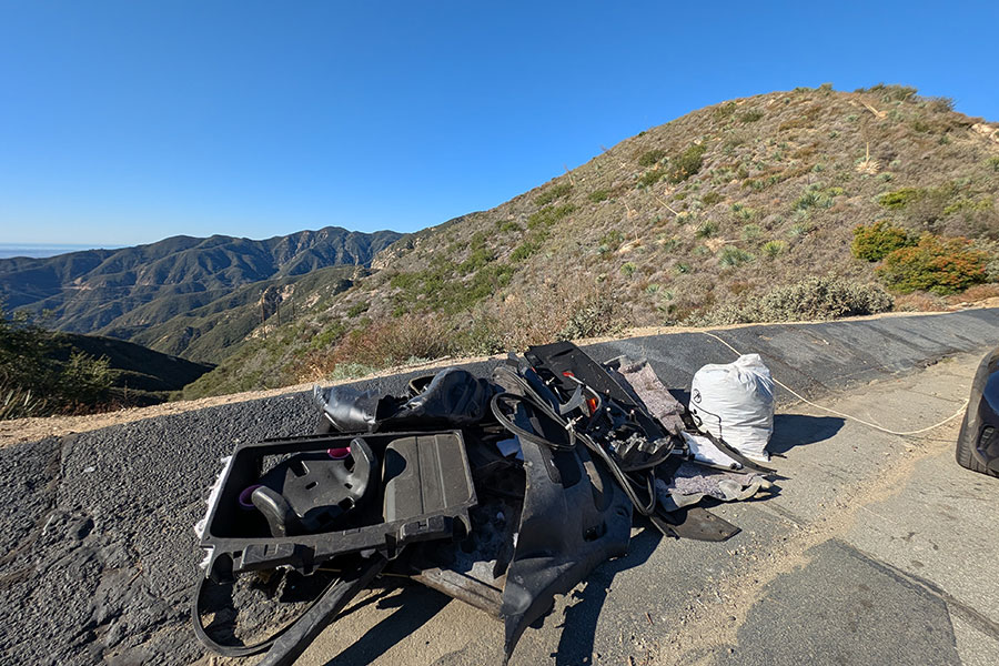 Car parts and trash at the top of a mountain overlook